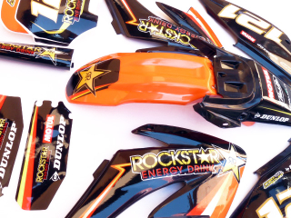 pitbike černé plasty CRF70 s polepy Rockstar/oranžové, Stomp, DemonX, WPB